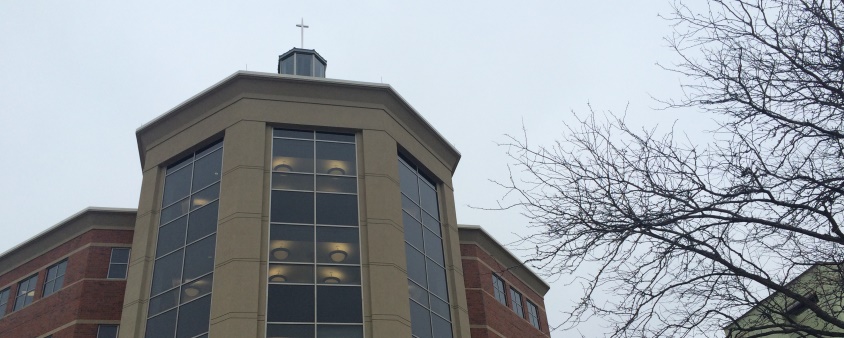 photo taken looking up the building at the cross on the quad-side of Kindlon Hall