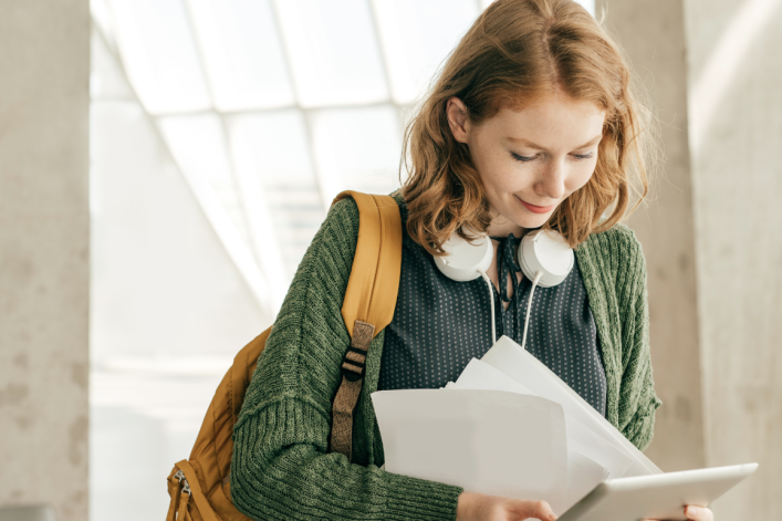 female student looking at student loan paperwork