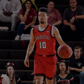 Benedictine Men's Basketball player dribbling the basketball