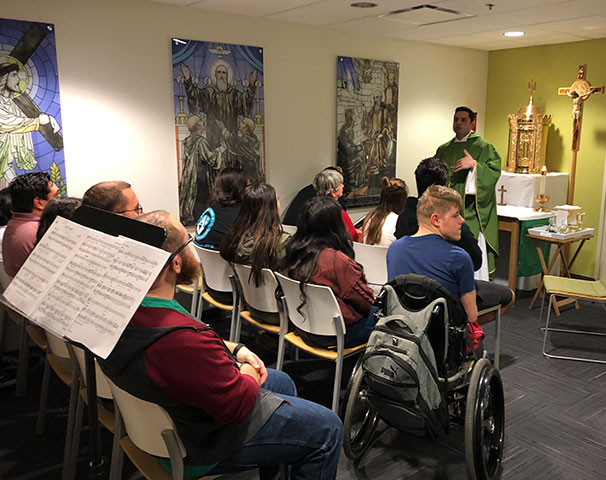 Priest leading a mass in Mesa Chapel - Campus Ministry Obligations