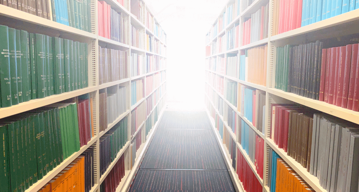 bright light at the end of a row with library books on both sides