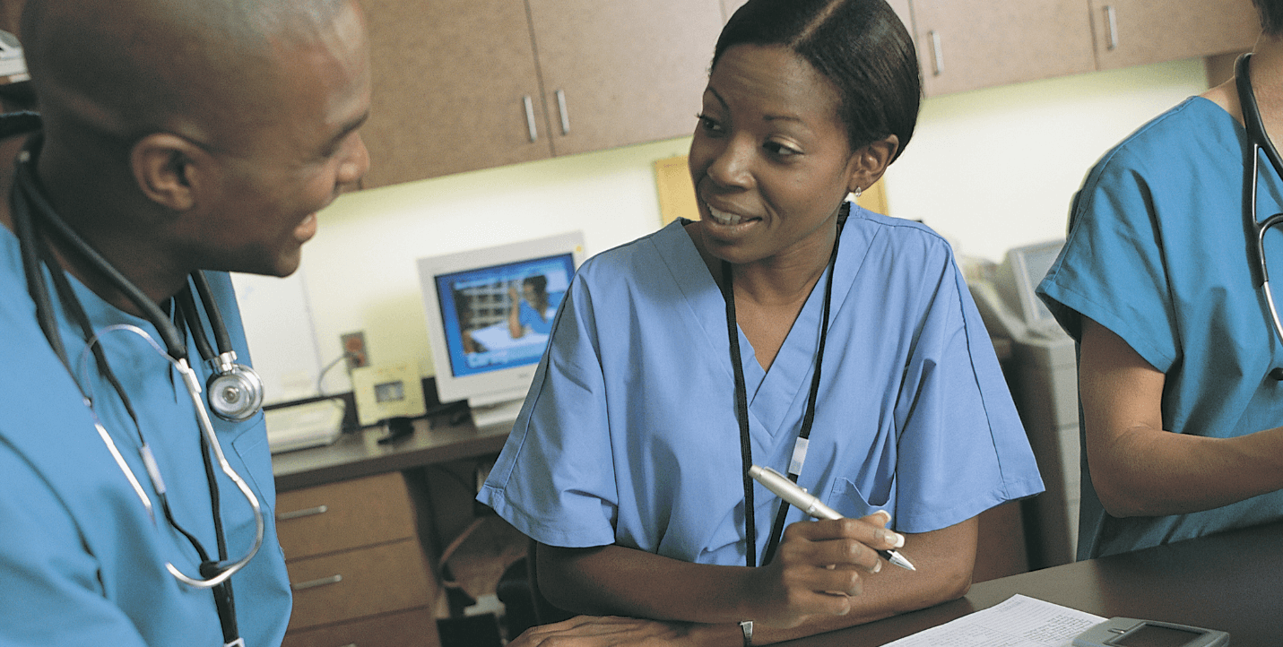 female pre-professional student speaking with male doctor - pre-physician assistant program
