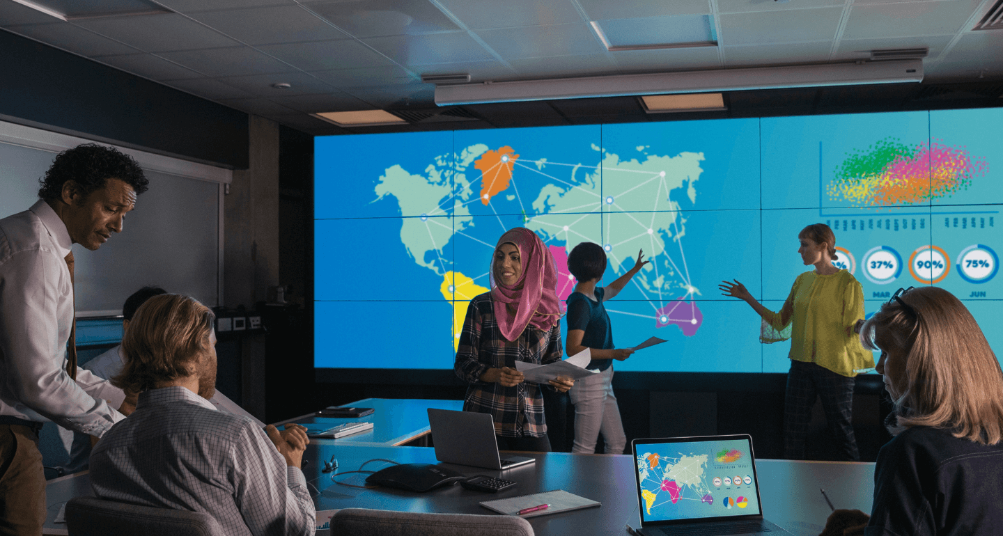 students working on large, interactive smart-board in international business class
