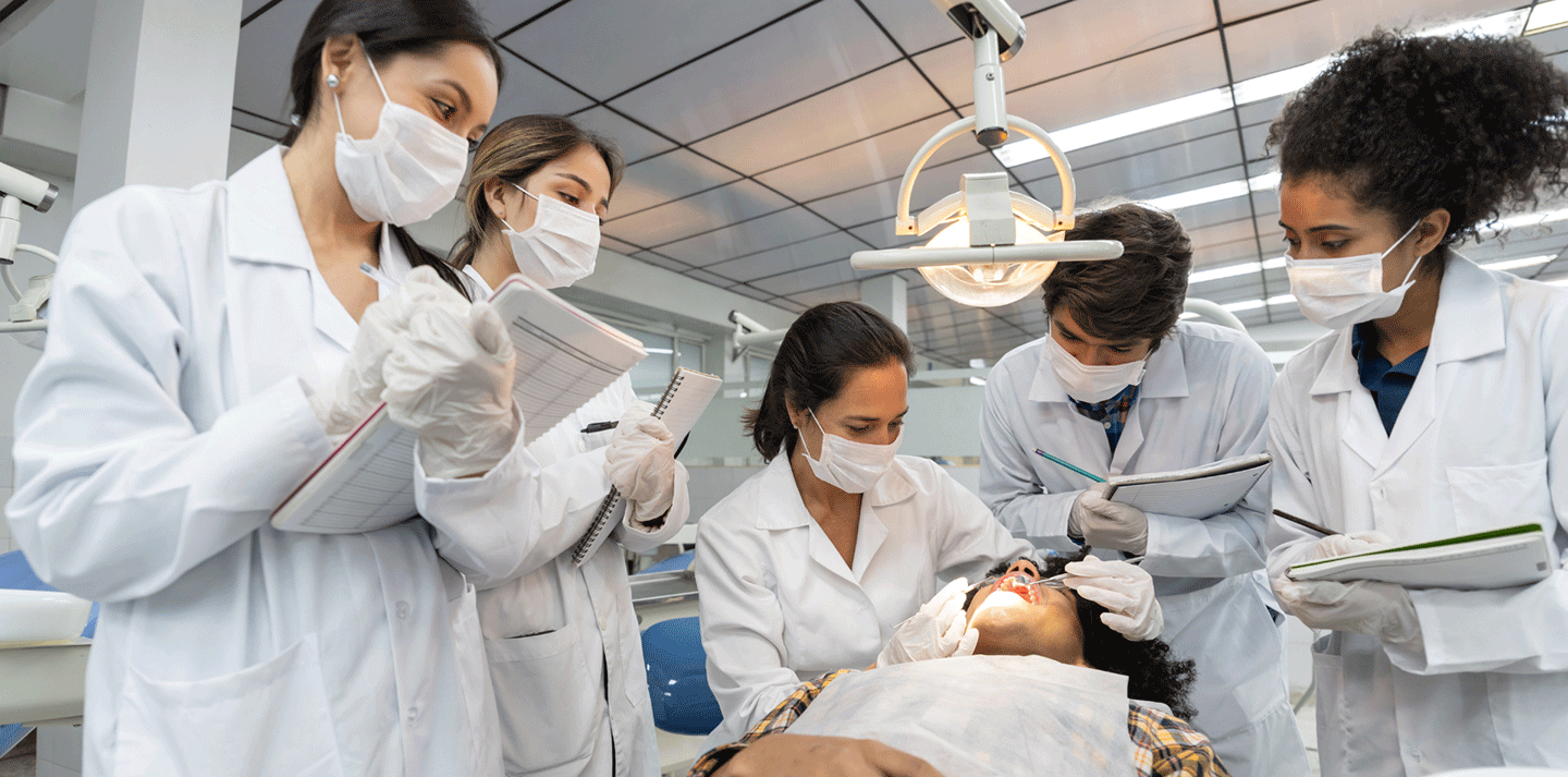 Pre-professional pre-dental students observing dentist work on patient