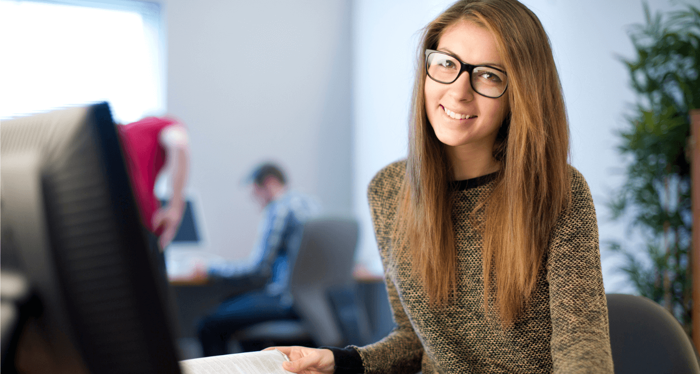 female student with hand on a book