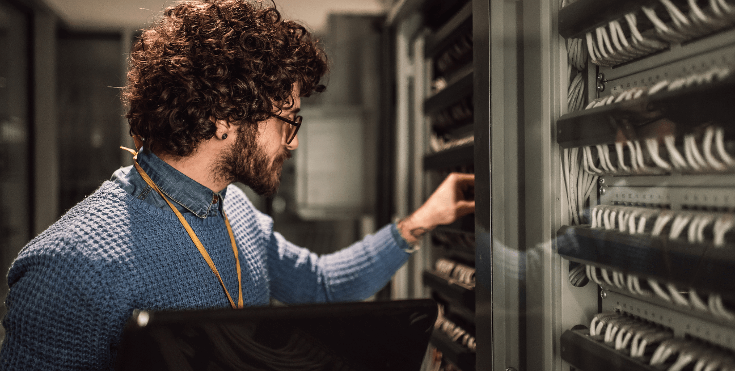 male working in server room - management information systems program