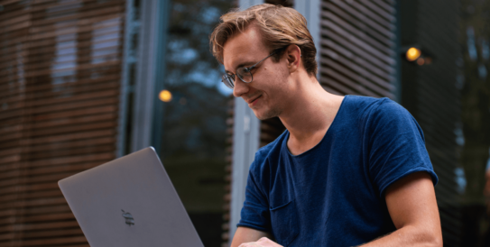 male student working on laptop