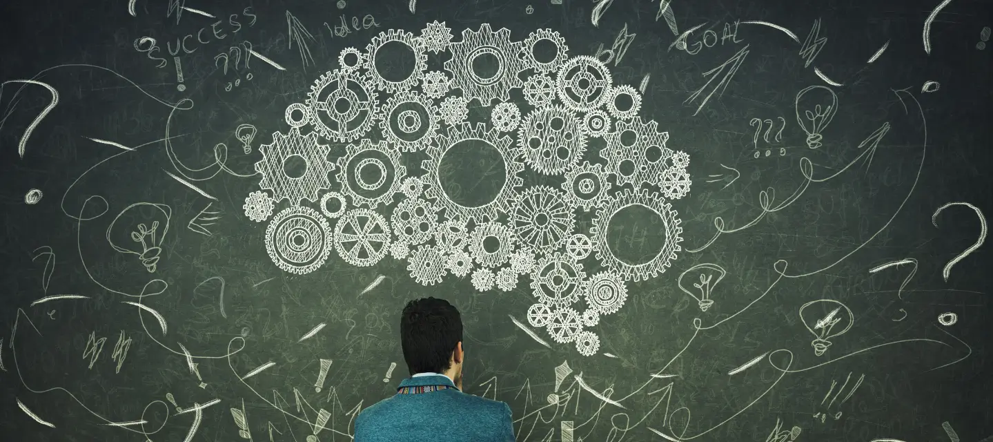 interacting gears drawn on a chalkboard - psychology