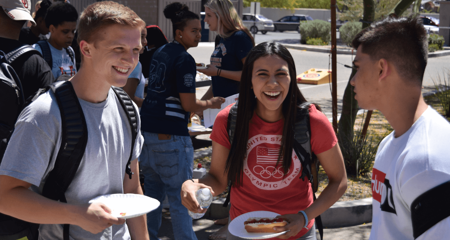students laughing at outdoor picnic