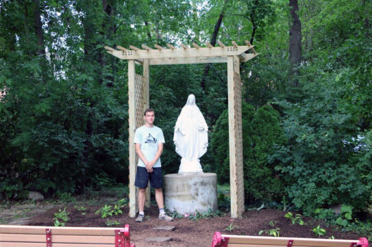 John Viehmann stands with updated Mary statue