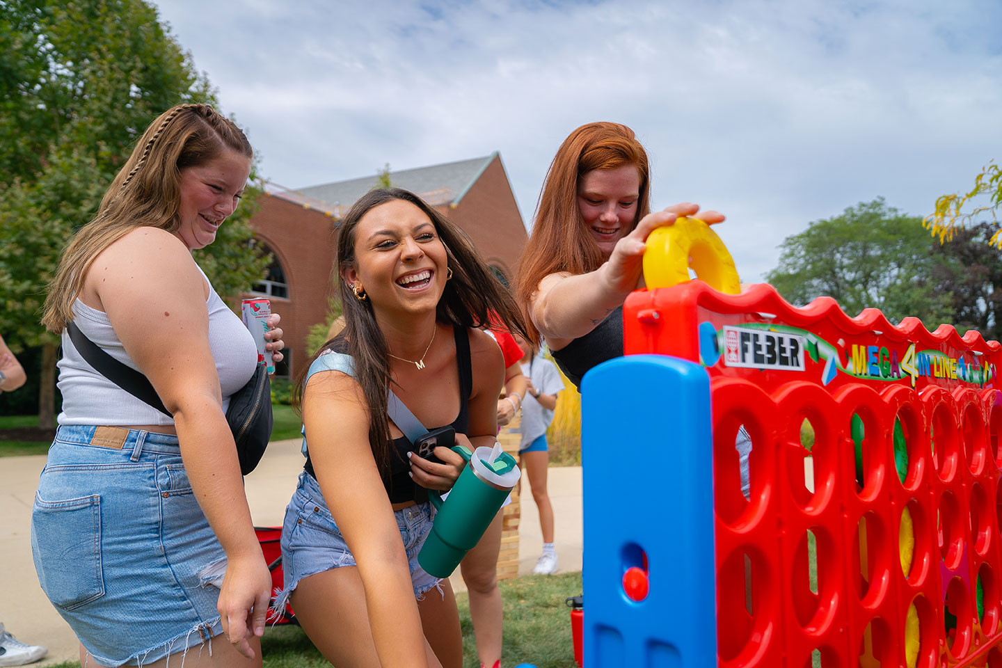 Freshman girls playing connect 4 at BenU carnival
