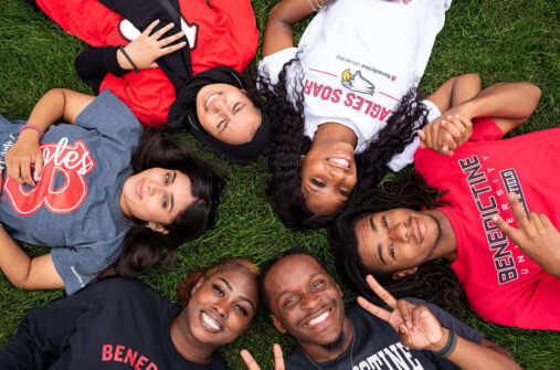students laying on ground with heads together